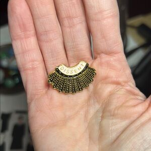 “Dissent” pin from Etsy. Justice Ruth Bader Ginsberg’s iconic necklace in a pin.